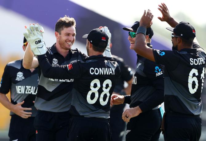 Adam Milne celebrates with Devon Conway after dismissing Mohammad Shahzad 