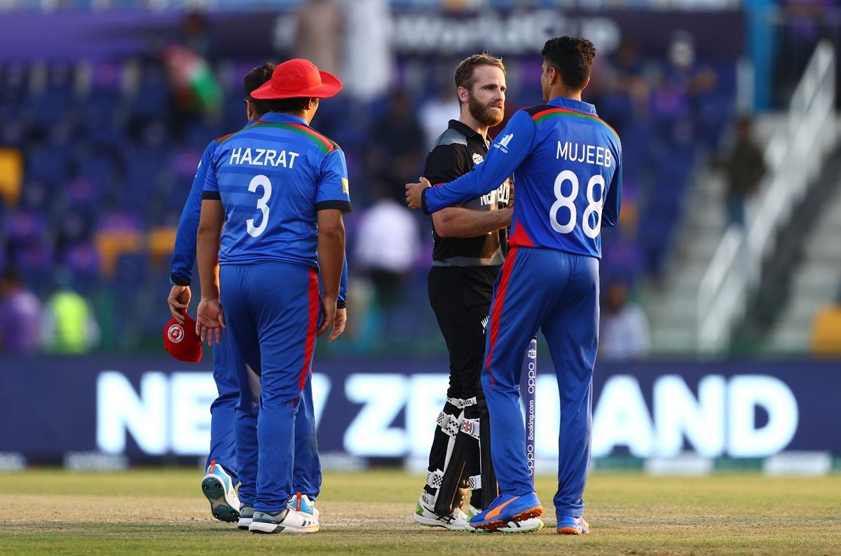 Kane Williamson is congratulated by Mujeeb Ur Rahman after victory is sealed.