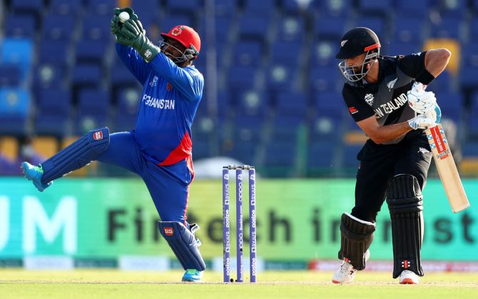 Mohammad Shahzad takes the catch to dismiss New Zealand opener Daryl Mitchell.