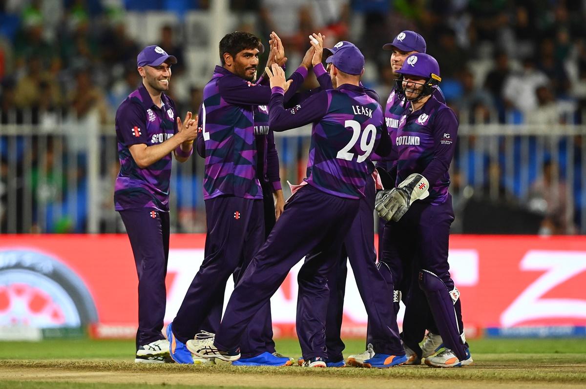 Scotland's spinner Hamza Tahir celebrates with teammates after dismissing  Pakistan opener Mohammad Rizwan.