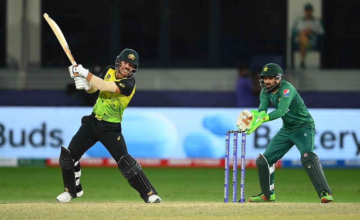 Australia opener David Warner drives to the boundary.