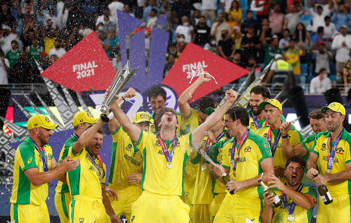 Australia's Mitchell Marsh celebrates with the trophy and teammates 
