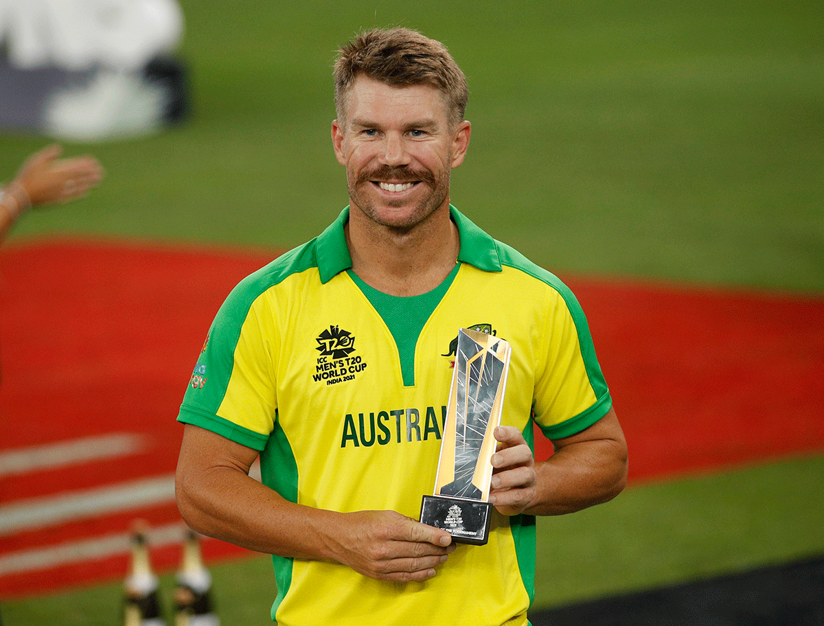 Australia's David Warner poses with the player of the tournament trophy after the T20 World Cup final on Sunday 