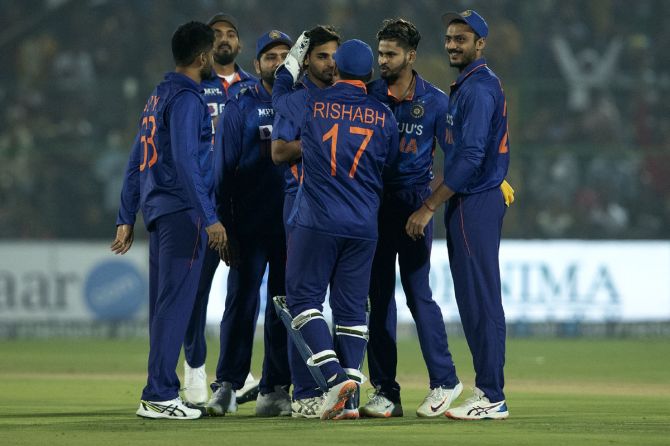 India's players celebrate the wicket of New Zealand opener Daryl Mitchell.