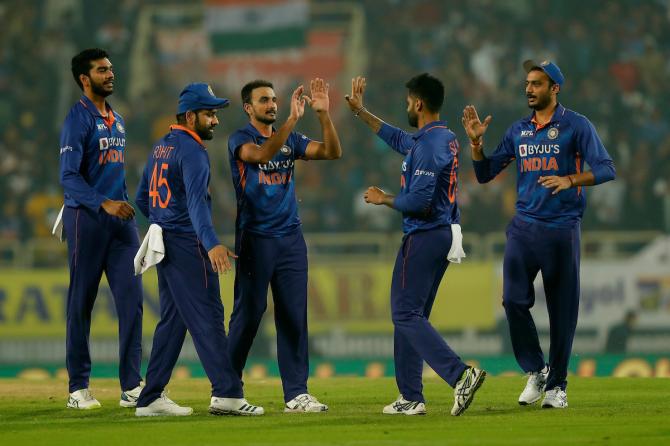 Harshal Patel is congratulated by teammates after dismissing New Zealand opener Daryl Mitchell and picking his first international wicket.