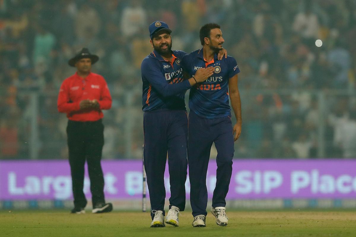 Harshal Patel is congratulated by skipper Rohit Sharma after dismissing Jimmy Neesham.