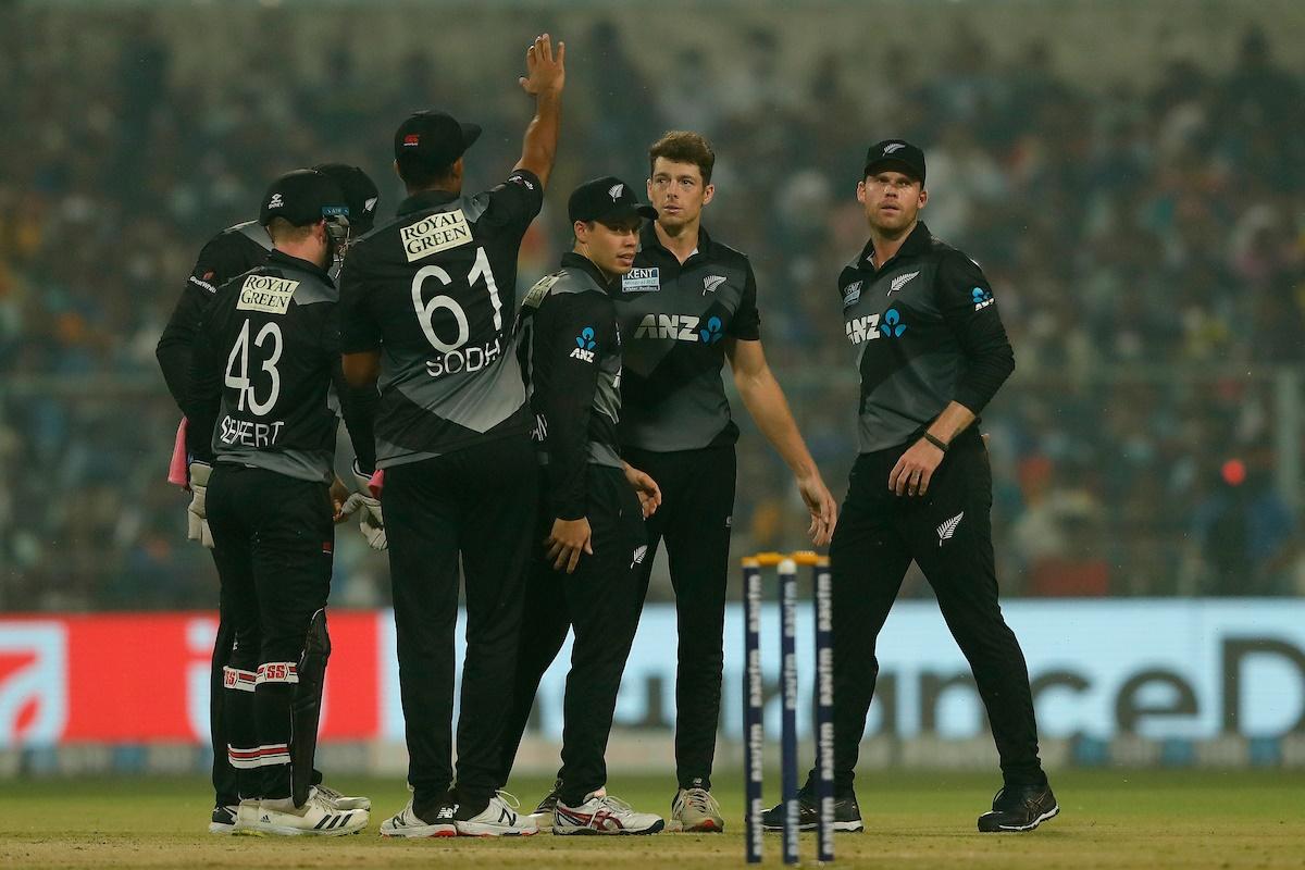 New Zealand spinner Mitchell Santner celebrates with teammates after dismissing Ishan Kishan.