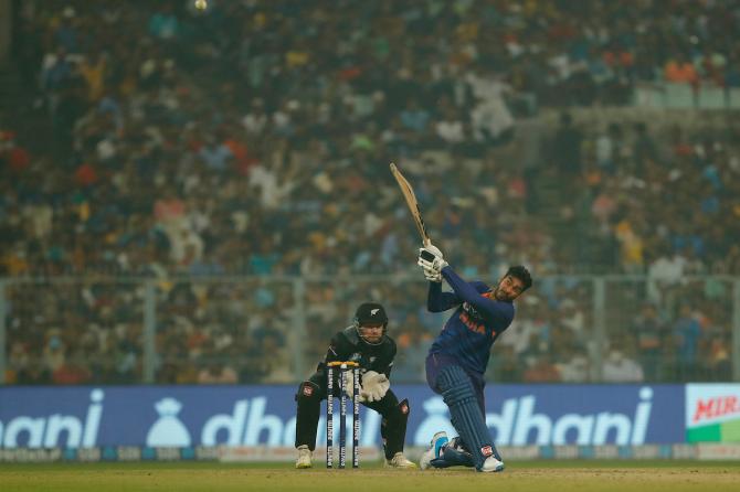 Venkatesh Iyer sends the ball over the boundary.