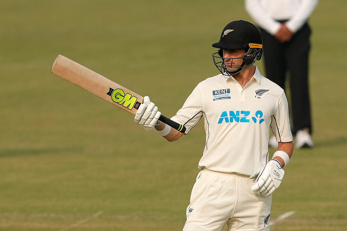 William Young waves to the dressing room after completing a half-century.