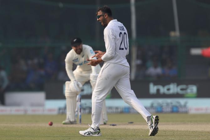 AIndia spinner Axar Patel celebrates after dismissing Tom Blundell.