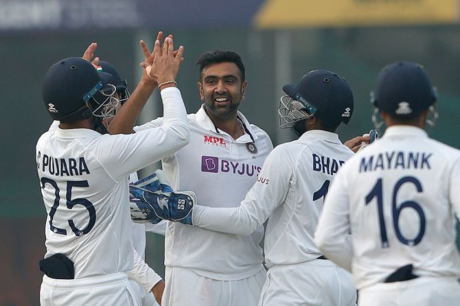 Ravichandran Ashwin celebrates with his India teammates after dismissing Tom Blundell.