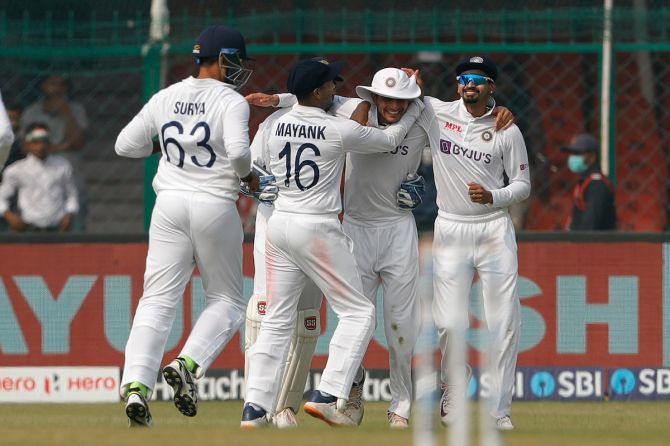 Shubman Gill is congratulated by his India teammates after taking the catch, off Umesh Yadav's bowling, to dismiss William Somerville.