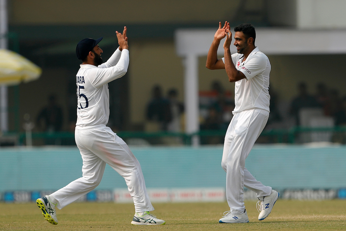 Ravichandran Ashwin celebrates with Cheteshwar Pujara after dismissing Tom Latham.