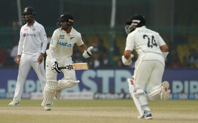 Rachin Ravindra and Ajaz Patel run a quick single during their gutsy last-wicket stand, which enabled New Zealand draw the first Test against India, in Kanpur, on Monday.