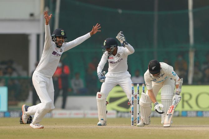 India's players celebrate as Kane Williamson is trapped leg before wicket by Ravindra Jadeja.