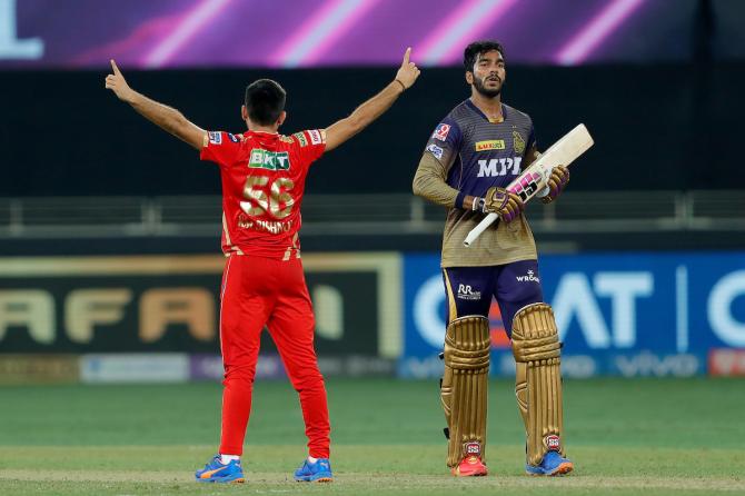 Venkatesh Iyer walks back after a splendid 67 off 49 balls, as Ravi Bishnoi celebrates his dismissal.