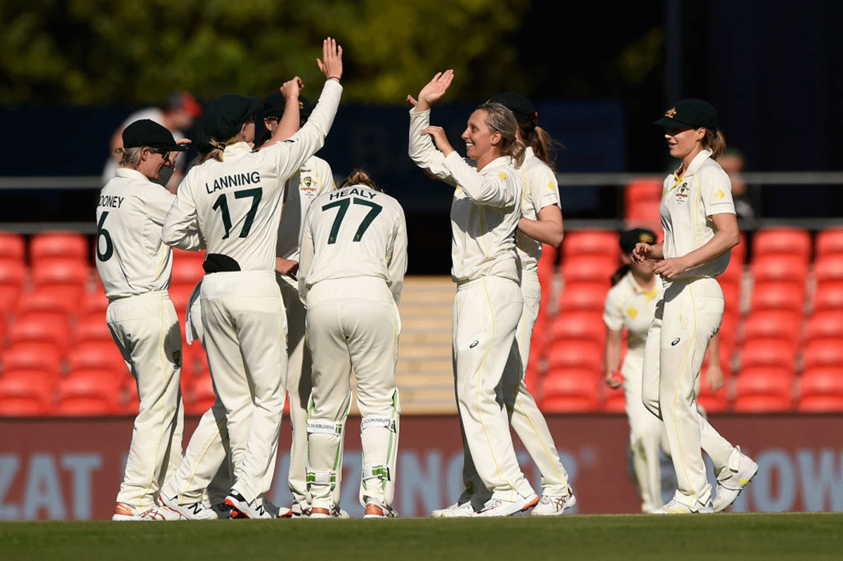 Australia's Ashleigh Gardner celebrates with teammates after taking the wicket of India's Smriti Mandhana