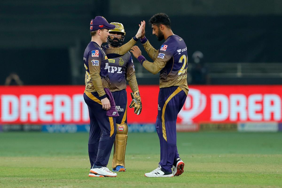 Varun Chakaravarthy is congratulated by skipper Eoin Morgan after taking the wicket of Mayank Agarwal.