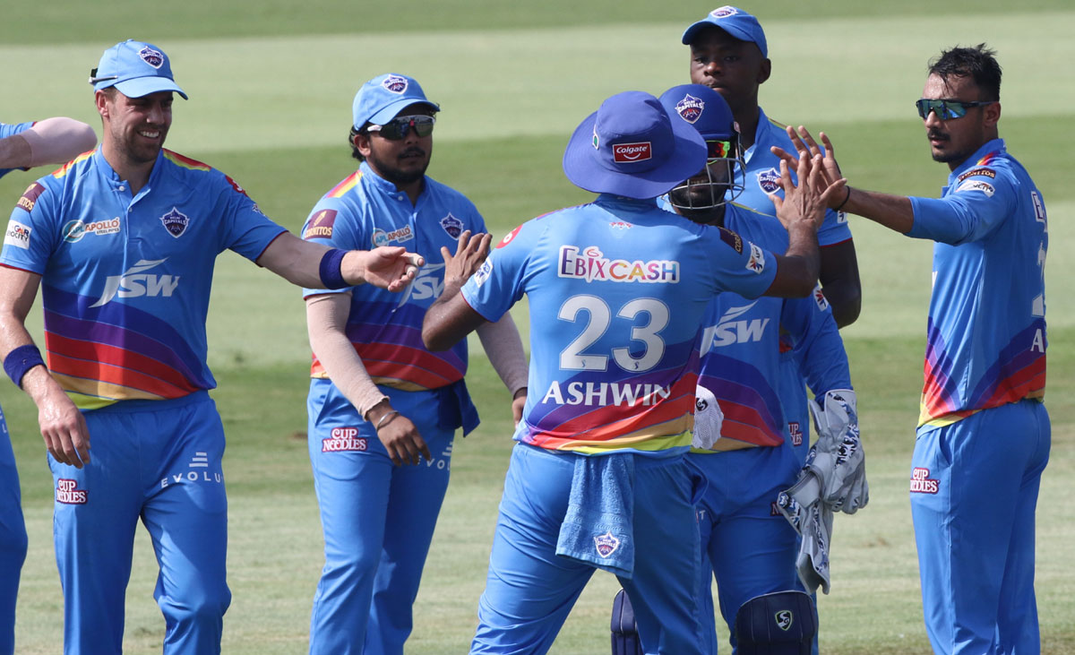 Spinner Axar Patel is congratulated by his Delhi Capitals teammates after dismissing Quinton de Kock.