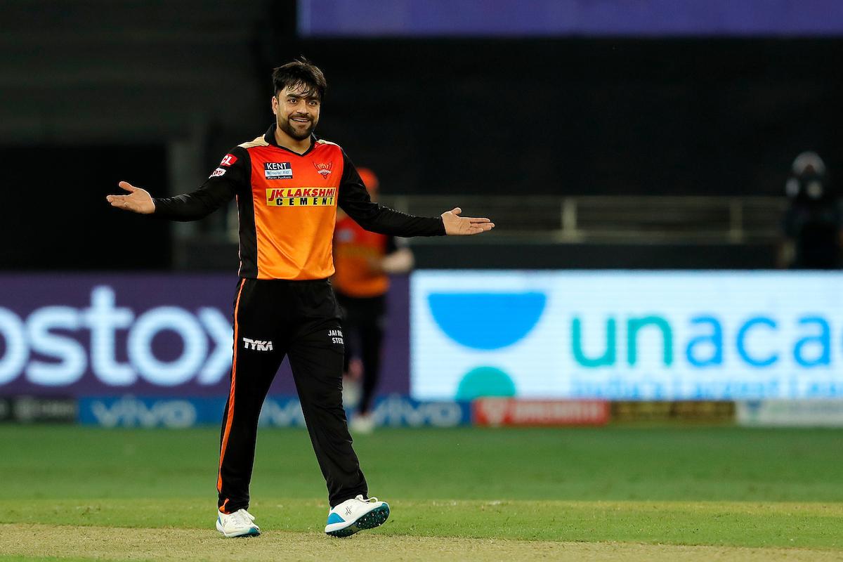 Rashid Khan celebrates the wicket of Rahul Tripathi.