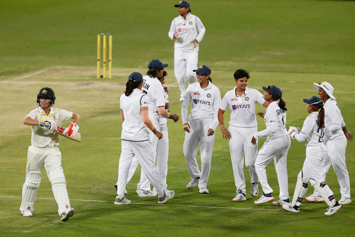 Indian players celebrate the wicket of Australia's Beth Mooney on Day 4 of the Women's International Pink-ball Test Match at Metricon Stadium in Gold Coast, Australia, on Sunday