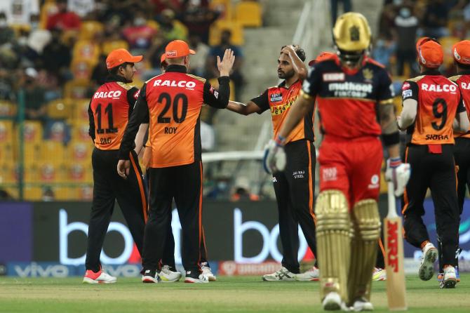 Sunrisers Hyderabad players celebrate after Bhuvneshwar Kumar traps Royal Challengers Bangalore opener Virat Kohli leg before wicket.