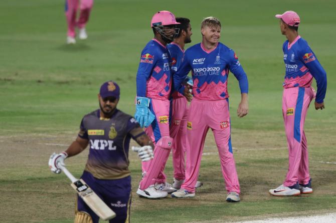 Nitish Rana walks back as Glenn Philipps, centre, celebrates the dismissal with his Rajasthan Royals teammates.