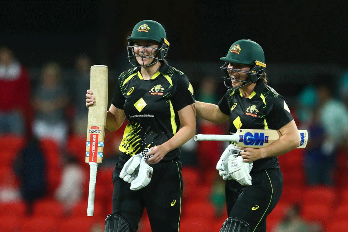 Australia's Tahlia McGrath and Georgia Wareham celebrate winning game two of the Women's International T20 series against India at Metricon Stadium in Gold Coast on Saturday