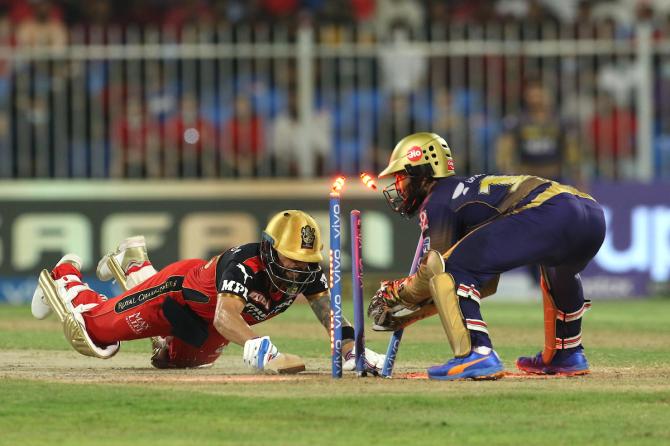 Virat Kohli dives to make his crease as Dinesh Karthik takes the bails off.