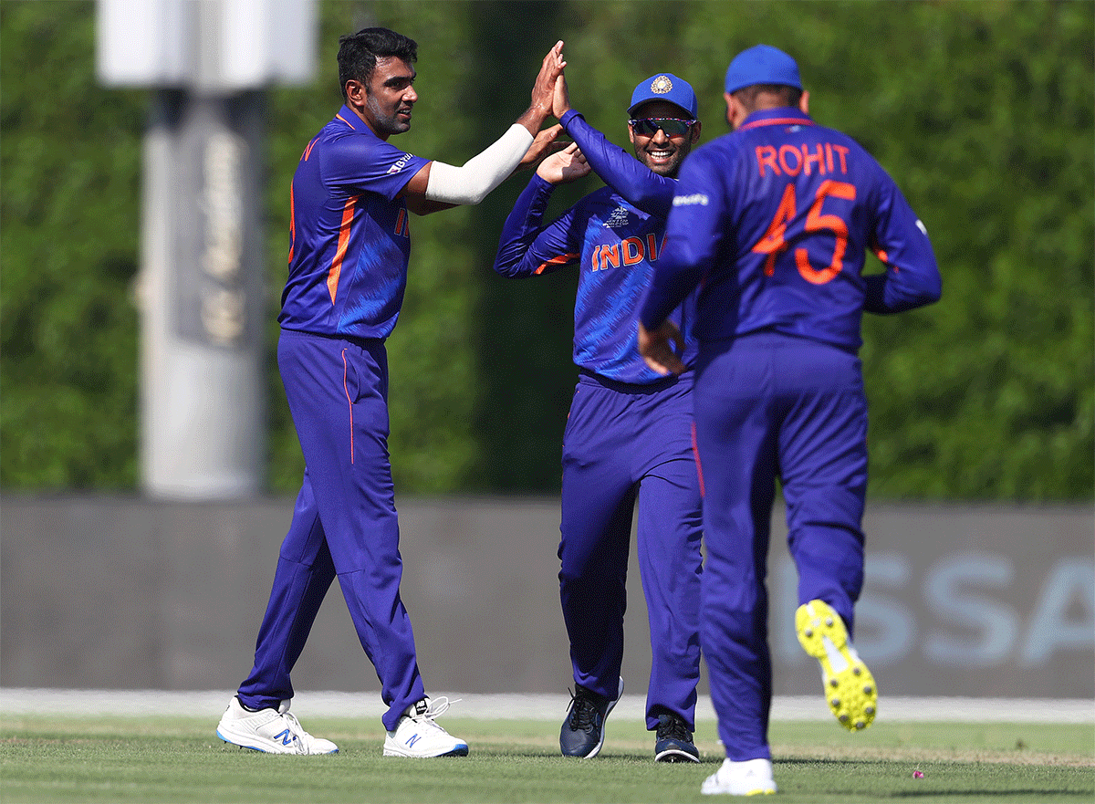 Ravichandran Ashwin celebrates with teammates after dismissing David Warner