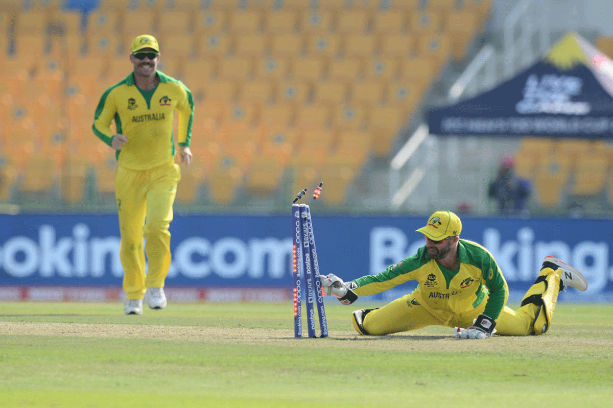 Matthew Wade breaks the stumps to have Keshav Maharaj run out