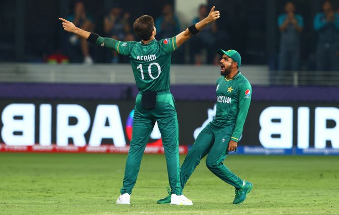 Shaheen Afridi celebrates the wicket of K L Rahul with teammate Babar Azam.