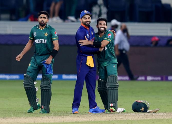 India's captain Virat Kohli congratulates Pakistan's Mohammad Rizwan as Babar Azam looks on after the T20 World Cup match in Dubai on Sunday.