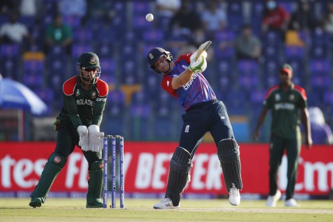 Jos Buttler steps out to send the ball over the boundary.