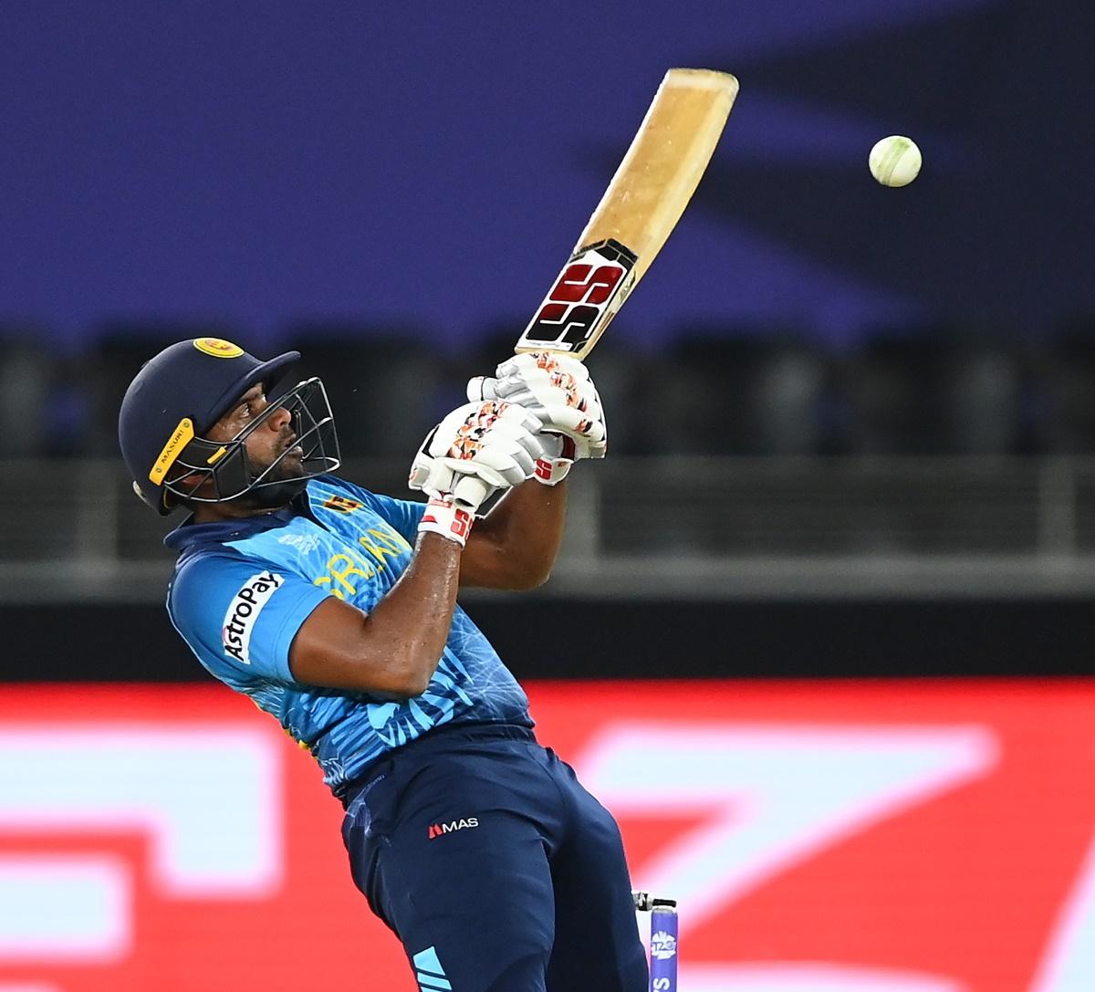 Sri Lanka's Bhanuka Rajapaksa connects a bouncer to the boundary.