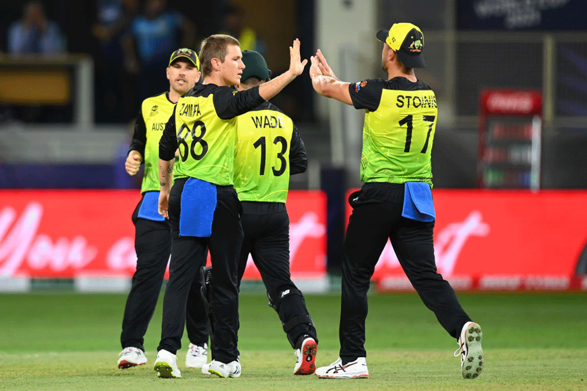 Australia spinner Adam Zampa celebrates the wicket of Charith Asalanka with teammate Marcus Stoinis.