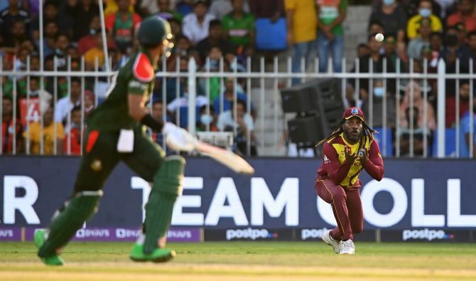 Chris Gayle pulls off a superb catch to dismiss Bangladesh batter Soumya Sarkar during the T20 World Cup Super 12s match, at Sharjah Cricket Stadium, on Friday.