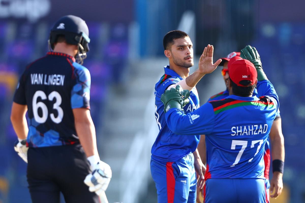 Naveen-ul-Haq celebrates with Mohammad Shahzad after dismissing Namibia opener Craig Williams (not in picture).