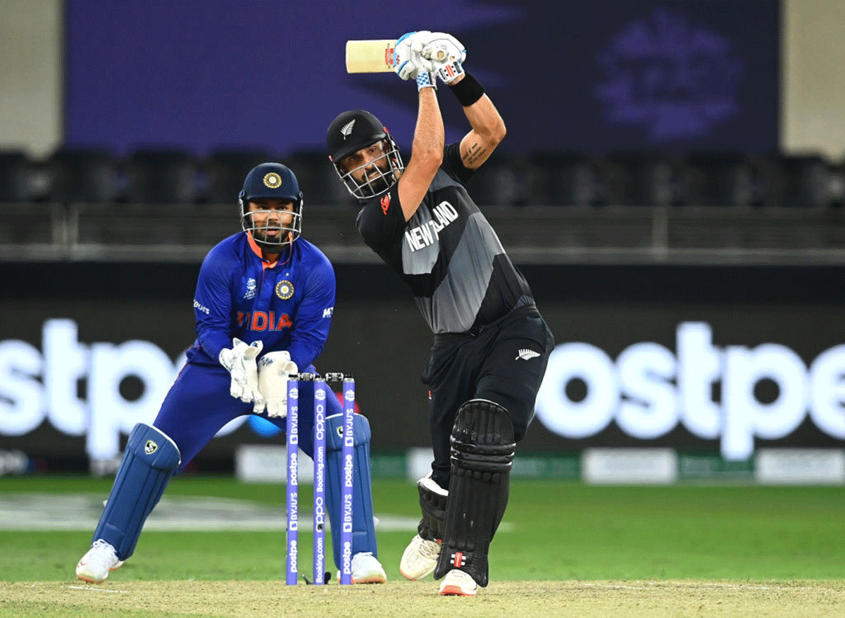 New Zealand's top-scorer Daryl Mitchell (49) bats as India keeper Rishabh Pant looks on. 