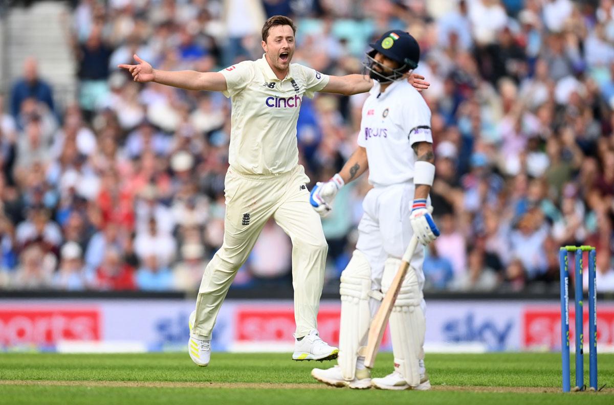 Ollie Robinson celebrates dismissing Virat Kohli.