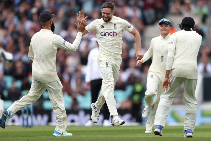 England pacer Chris Woakes celebrates after Jonny Bairstow catches India opener Rohit Sharma early on Day 1 of the fourth Test, at the Oval in London, on Thursday.