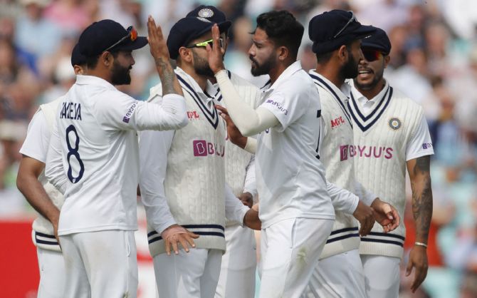 Mohammed Siraj celebrates with teammates after dismissing Jonny Bairstow.