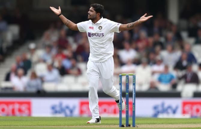 Umesh Yadav celebrates taking the wicket of Dawid Malan.