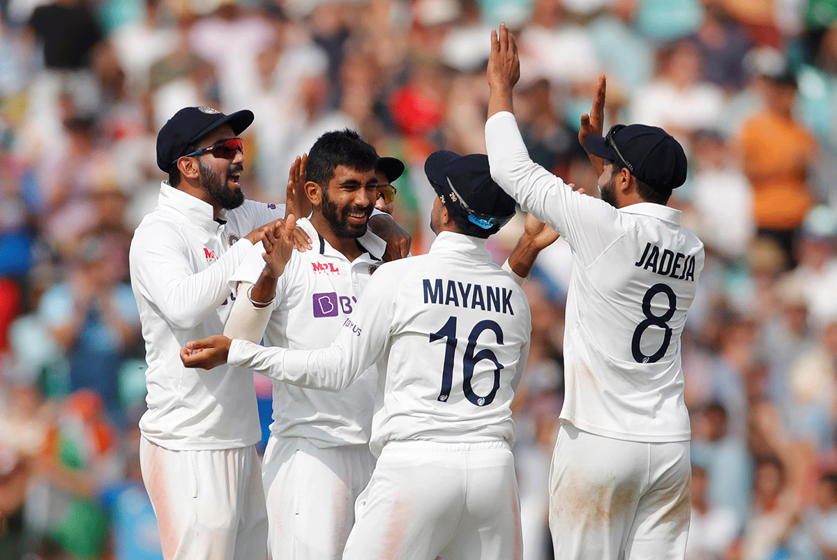 India's Jasprit Bumrah celebrates with teammates after taking the wicket of England's Jonny Bairstow on Day 5 of the 4th Test at the Oval in London on Monday 