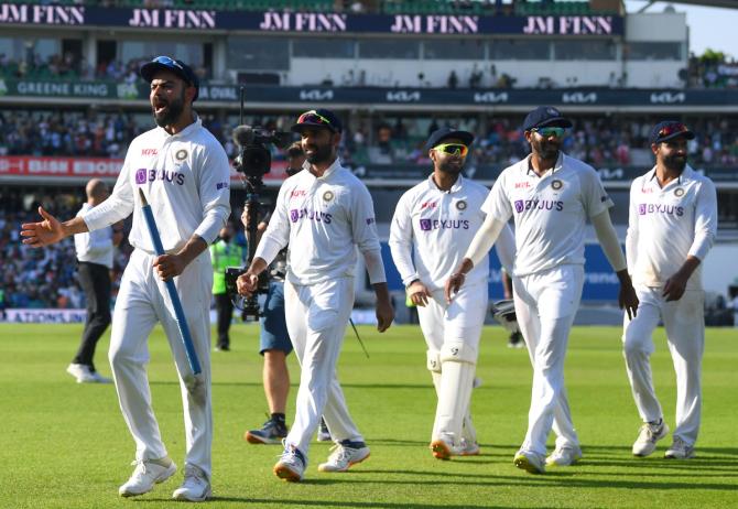 Virat Kohli leads off his team after winning the fourth Test