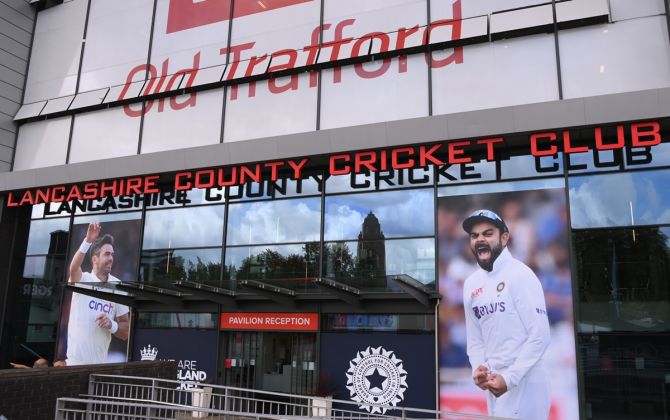 Pictures of England pacer James Anderson, left, and India captain Virat Kohli adorn the entrance to the old pavilion ahead of the fifth and final Test, at Old Trafford in Manchester, England.
