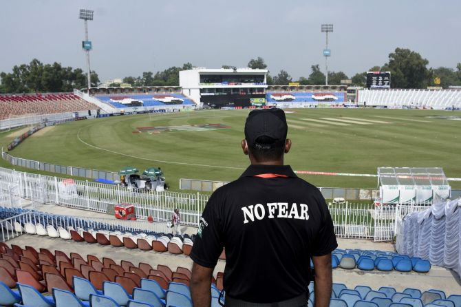A member of the Police Elite Force stands guard at the Rawalpindi Cricket Stadium, after the New Zealand cricket team pulled out of a Pakistan cricket tour over security concerns.