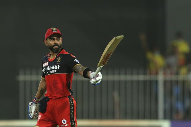 Royal Challengers Bangalore captain Virat Kohli waves to his dressing room after scoring 50.