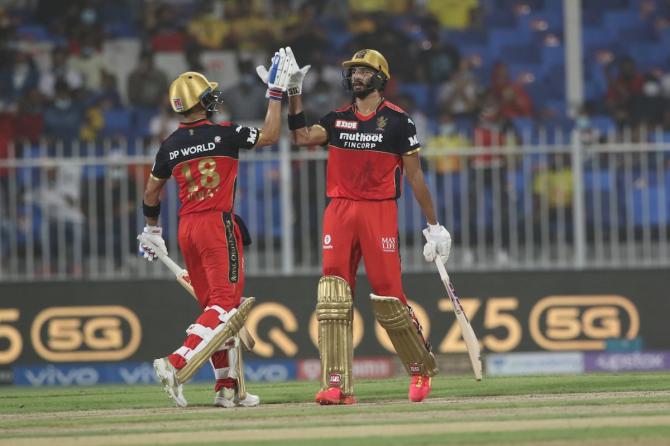 Devdutt Padikkal gets a high-five from skipper Virat Kohli after completing 50