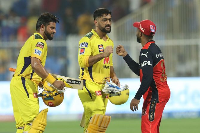 Chennai Super Kings batters Suresh Raina and Mahendra Singh Dhoni walk back after sealing victory over Royal Challengers Bangalore in the Indian Premier League match, in Sharjah, on Friday. 